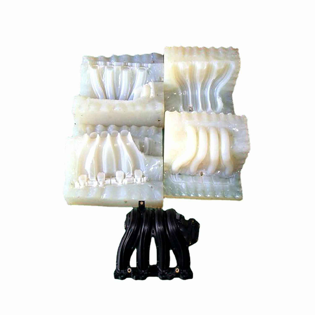 A glossy red model of a classic car, resembling a Volkswagen Beetle, is placed on top of a neat stack of colorful, rectangular plastic sheets. The car and sheets exhibit a shiny, reflective surface, showcasing Custom Plastic Vacuum Forming with world-class quality against a simple gradient from white to gray